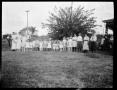 Photograph: [Photograph of Adolescents and Children in Line]