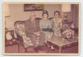 Photograph: [Photograph of Three Unknown People Sitting on Couch]