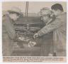 Clipping: [Newspaper Clipping of Daniel Brothers and Keenan Working on Tractor]