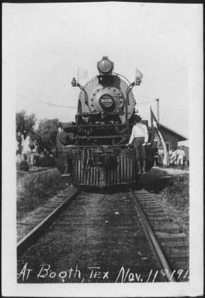 Primary view of object titled '[Postcard image of a man standing on the front of a locomotive]'.