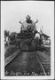 Thumbnail image of item number 1 in: '[Postcard image of a man standing on the front of a locomotive]'.