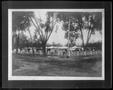 Photograph: [White buildings surounded by a fence in Cuba]