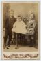 Photograph: [Photograph of Two Children and One Infant]