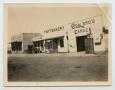 Photograph: [Photograph of Businesses Along a Dirt Road]