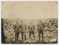 Primary view of [Photograph of Four Soldiers in Front of a Rock Wall]