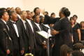 Photograph: [Conductor directs choir during performance]