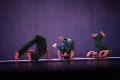 Photograph: [Photograph of three dancers doing somersaults on stage]