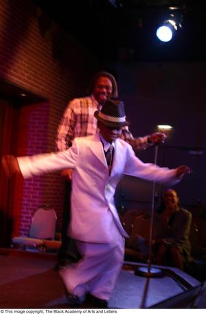 Primary view of object titled '[Boy in white suit and Curtis King on stage]'.