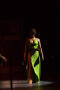 Photograph: [Performer in green dress in spotlight]