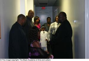 Primary view of object titled '[Rachel Webb, Kirondria Woods, Curtis King, and several other standing in hallway]'.