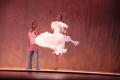 Photograph: [Dancer lifting her dress skirt]