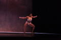 Primary view of [Solo dancer squatting on stage]