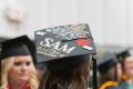Photograph: [Journalism Master's Graduate wearing decorated cap]