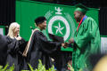 Thumbnail image of item number 1 in: '[Dorothy Bland shaking hands with Undergraduate Student at Commencement Ceremony]'.