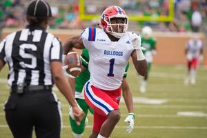 Primary view of object titled '[LA Tech player running the ball]'.