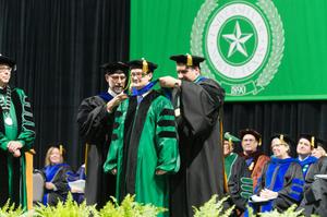Primary view of object titled '[Ph.D Candidate Being Presented with Doctoral Hood, 3]'.