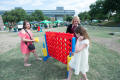 Photograph: [Family plays giant Connect Four game]