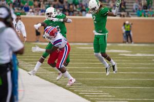 Primary view of object titled '[North Texas Football player evades opposing player]'.