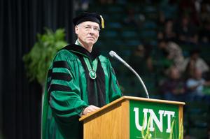 Primary view of object titled '[Faculty Member Standing At Podium During Commencement Ceremony]'.