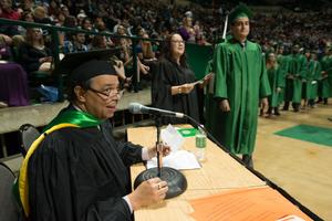 Primary view of object titled '[Faculty Member Annoucing Names at Bachelor Commencement Ceremony]'.