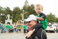 Primary view of [Grandparent with Grandchild at Homecoming Parade]