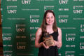Primary view of [Leta Cunningham standing with first place Ten Spurs award]