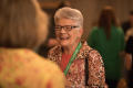 Photograph: [Attendee laughing during conversation]