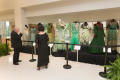 Photograph: [Guests looking at fashion dresses displayed during the Wingspan Gala]