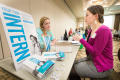 Photograph: [Two women talking to each other at Career Fair]