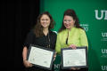 Photograph: [Two women receiving Certificate's of Achievement]