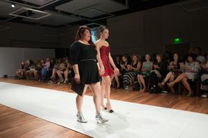 Primary view of object titled '[Fashion design student with model during ArtWear runway]'.