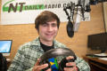 Thumbnail image of item number 1 in: '[NT Daily Radio student holding headphones in his hands]'.
