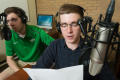 Photograph: [Two NT Daily Radio students sitting at a desk]