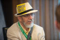 Photograph: [Jeffrey Weiss wearing hat with note attached]