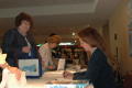 Photograph: [Woman autographing books at the 2006 CSLA conference]