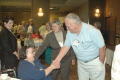 Photograph: [Warren Livingston shaking hands with guest at CSLA conference]