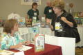 Thumbnail image of item number 1 in: '[Marjorie Smink talking with exhibitor]'.
