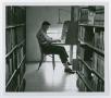 Photograph: [Student in the stacks]