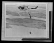 Thumbnail image of item number 1 in: '[Photograph of an individual parachuting from a YUH-1D Iroquois helicopter, 2]'.