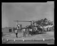 Photograph: [Photograph of individuals working on a YUH-1D Iroquois helicopter, 2]