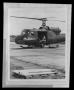 Photograph: [Photograph of individuals sitting inside a UH-1A Iroquois helicopter]