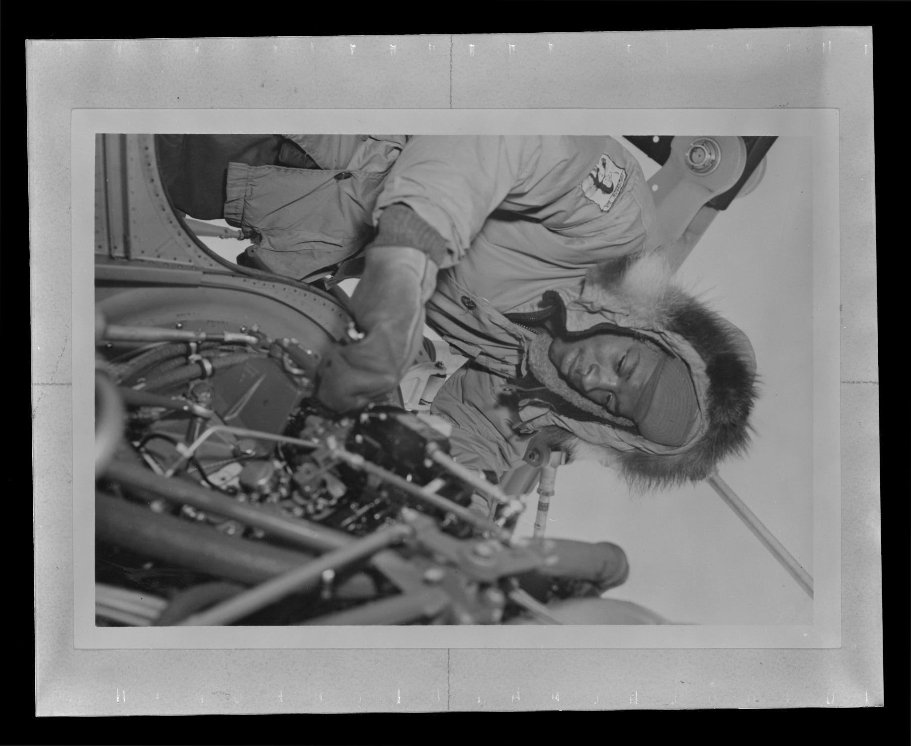[Photograph of a man working on a UH-1B Iroquois helicopter]
                                                
                                                    [Sequence #]: 1 of 1
                                                