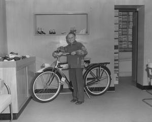 Primary view of object titled '[Portrait of a Young Boy Standing Next to a Bicycle]'.