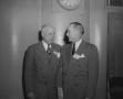 Photograph: [Two Older Men in Suits Socializing]