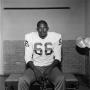 Photograph: [Football player sitting on a bench, 9]