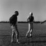 Photograph: [Football coach standing with a player]