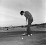 Photograph: [An unknown man about to make a putt, 2]