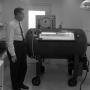 Photograph: [Dr. Donald Reddon with the decompression chamber #5]