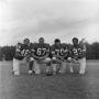 Photograph: [Four NTSU football players kneeling]