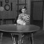 Photograph: [Man at table in prison uniform holding a chickens' legs]